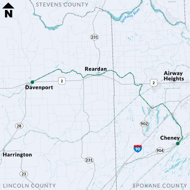 Map showing roads and towns in Lincoln County and Spokane County, highlighting routes such as U.S. Route 2 and Interstate 90. A line is drawn to indicate the location of the rail project though these towns and highways.