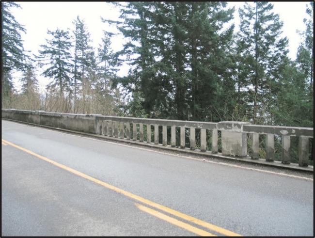 View from Chuckanut Drive of the railing on the concrete wall, 2016.