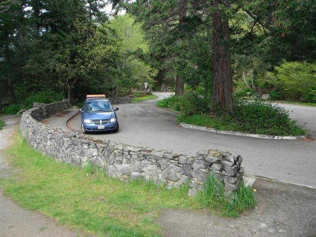 View of car on Chuckanut Drive at MP 12.45 with rock wall, 2017.