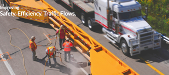A mobile barrier with workers and truck on a roadway