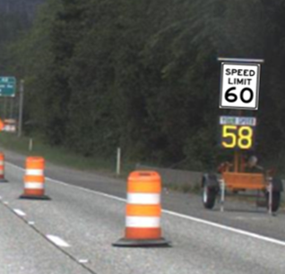 A radar speed feedback trailer on shoulder of the highway with right lane closed